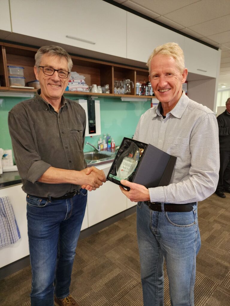 Tony Phillips holding 30 years service certificate